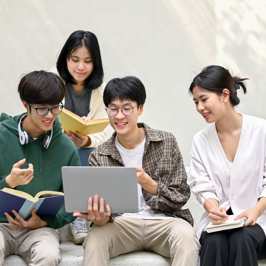 JC Economics students collaborating during their first tuition session, discussing concepts and reviewing study notes together