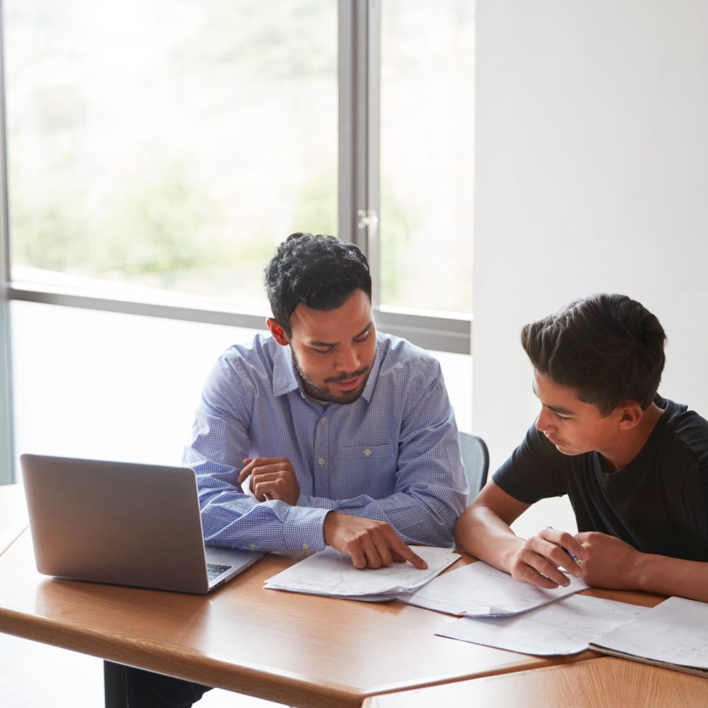 Tutor explaining lesson to student during focused one-on-one tuition for Economics session.