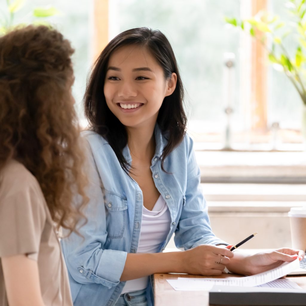 Tutor guiding student with notes during one-on-one tuition for Economics session